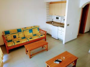 a living room with a couch and a kitchen at Apartamentos Jet - Adults Only in Playa d'en Bossa
