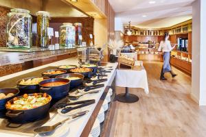 a buffet line with many pots and pans of food at Flamingo Beach Mate in Adeje