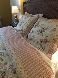 a bed with two pillows and a table with a lamp at Wynberg House Bed & Breakfast in Swansea