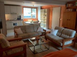 a living room with two couches and a table at Uni - Lübeck Appartement in Groß Grönau