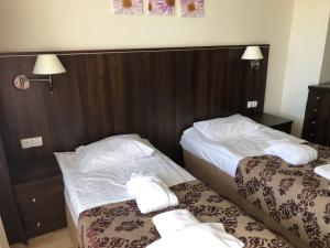 a hotel room with two beds with towels on them at Apartament Ania z widokiem na morze w Hotelu Arka in Kołobrzeg