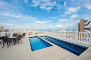 a balcony with a swimming pool on top of a building at Hotel da Villa in Fortaleza