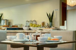 a table with plates of food on top at Hotel da Villa in Fortaleza