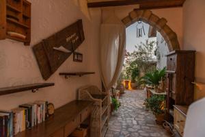 a hallway with an archway and a book shelf at Kalderimi Studios in Patmos