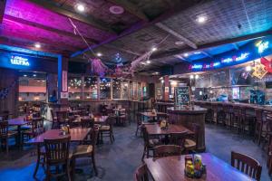 a restaurant with wooden tables and chairs and a bar at Paragon Casino Resort in Marksville