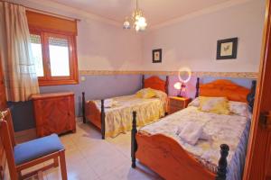 Ein Bett oder Betten in einem Zimmer der Unterkunft El Ventorrillo - holiday home with stunning views and private pool in Benissa