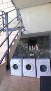 two washing machines sitting next to a stone wall at Finca Wawa Tenerife in Guía de Isora