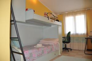 a small room with a bunk bed and a ladder at Villa Eva Luxury Villasimius in Villasimius