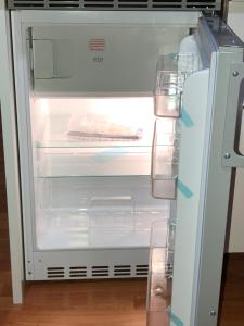 an empty refrigerator with its door open with its door at Apartment 4 Rent in Bochum