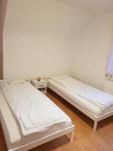 two beds sitting next to each other in a room at Ferienwohnungen Albstadt in Albstadt