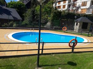 a large swimming pool in a yard with a light pole at PASEO DE LOS AYERBE Nº5 in Canfranc-Estación