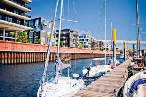 a group of boats docked at a dock in the water at Segelyacht Bremen City in Bremen