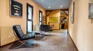 a living room with two chairs and a table at Hotel La Rambla in Biescas