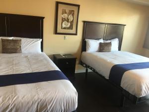 A bed or beds in a room at Budget Lodge San Bernardino