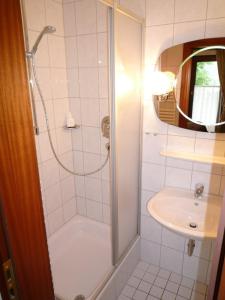 a bathroom with a shower and a sink at Hotel Garni Zeranka in Ruhpolding