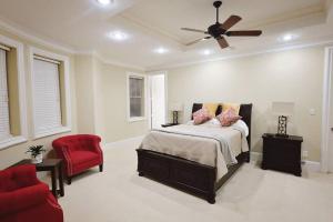 a bedroom with a bed and a ceiling fan at Downtown Museum District, Zoo, Parks, Nightlife! - Detering in Houston