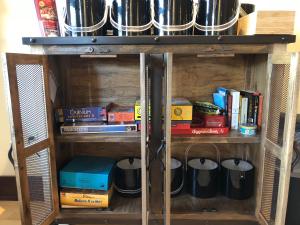 a book shelf filled with books and other items at Great Northern Resort (Lodge) in West Glacier