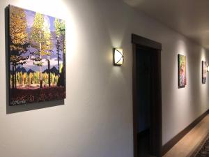 a room with a painting on the wall and a painting on the wall at Great Northern Resort (Lodge) in West Glacier