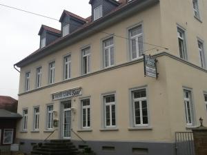 a white building with a sign in front of it at Hotel Saar in Kusel