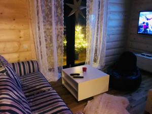 a living room with a couch and a coffee table at ChochołowskieSpanie in Chochołów