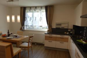 a kitchen with a table and a dining room at Haus Brunner in Bad Mitterndorf