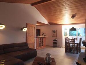 a living room with a couch and a table at Ferienhaus SEE Romantik mit Sauna und Whirlpool in Zislow
