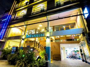 a store front of a building at night at Siri Poshtel Bangkok - SHA Extra Plus in Bangkok