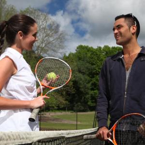 Ein Mann und eine Frau stehen über einem Tennisnetz in der Unterkunft Peppers Craigieburn Resort in Bowral