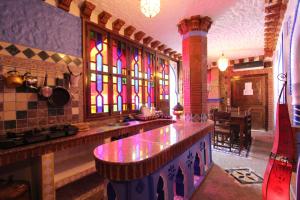 a kitchen with a counter and stained glass windows at Résidence Hoteliére Chez Aziz in Chefchaouen