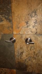a pair of metal handles on a tile floor at Loft Estudio El Faro - Zona Estero Beach in Ensenada