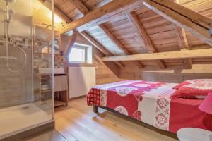 a bedroom with a bed and a glass shower at Le Charmélie 1600 in Flaine