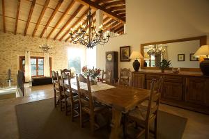 a dining room with a wooden table and chairs at Country House Horlandis in Petra