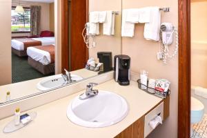 a bathroom with a sink and a mirror at Americas Best Value Inn Plattsburgh in Plattsburgh +30 photos