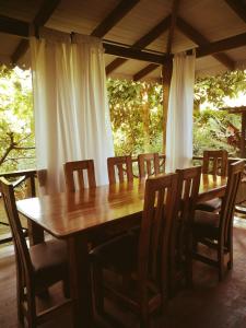 a wooden table and chairs in a room at Hotel Casitas Mar y Luz in Puerto Viejo
