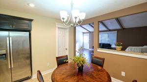 a dining room with a table and a kitchen at 350k Home, 5 BDR, Up to 16 guest, Middle of Town - Templar in Sugar Land