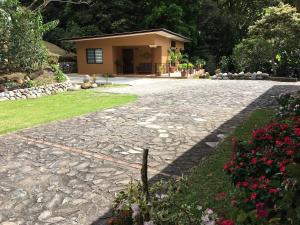 una entrada de piedra con una casa en el fondo en Finca Caramelo, en Boquete