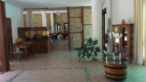 a living room with a lobby with a table and a dining room at Hylatio Tourist Village in Pissouri