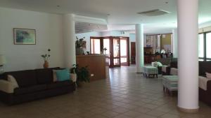 a living room with couches and chairs in a building at Hylatio Tourist Village in Pissouri