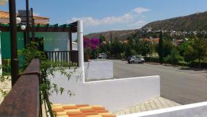 a parking lot with a car driving down a street at Hylatio Tourist Village in Pissouri