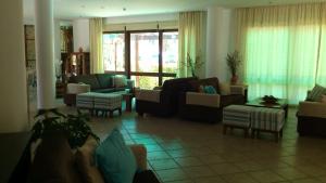 a living room with couches and chairs at Hylatio Tourist Village in Pissouri