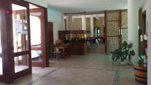 a lobby with an open door and a dining room at Hylatio Tourist Village in Pissouri