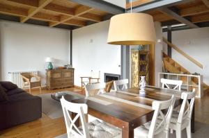 a living room with a wooden table and chairs at Quinta da Longra in Alvarenga