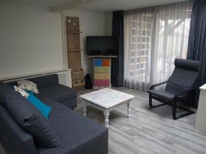 a living room with a couch and a coffee table at JaBaKi Child friendly home in Hoofddorp