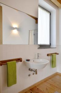 a bathroom with a white sink and a window at Quinta da Longra in Alvarenga
