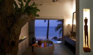 a bathroom with a tub with a view of the ocean at Tadrai Island Resort in Mana Island