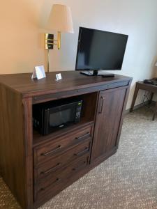 a television on top of a wooden entertainment center at Yellowstone Lodge in West Yellowstone