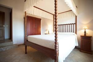 a bedroom with a four poster bed in a room at Country House Horlandis in Petra