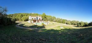 a house sitting on top of a grassy hill at Country House Horlandis in Petra