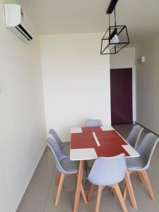 a dining room with a table and chairs at V’Auliya Residence in Putrajaya