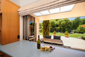 an open patio with a table with a bowl of fruit at Lake View by Town in Taupo